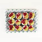 Aubergine Salad platter for six from above, aubergine discs topped with bulgur, pomegranate and yogurt on Route Catering paper