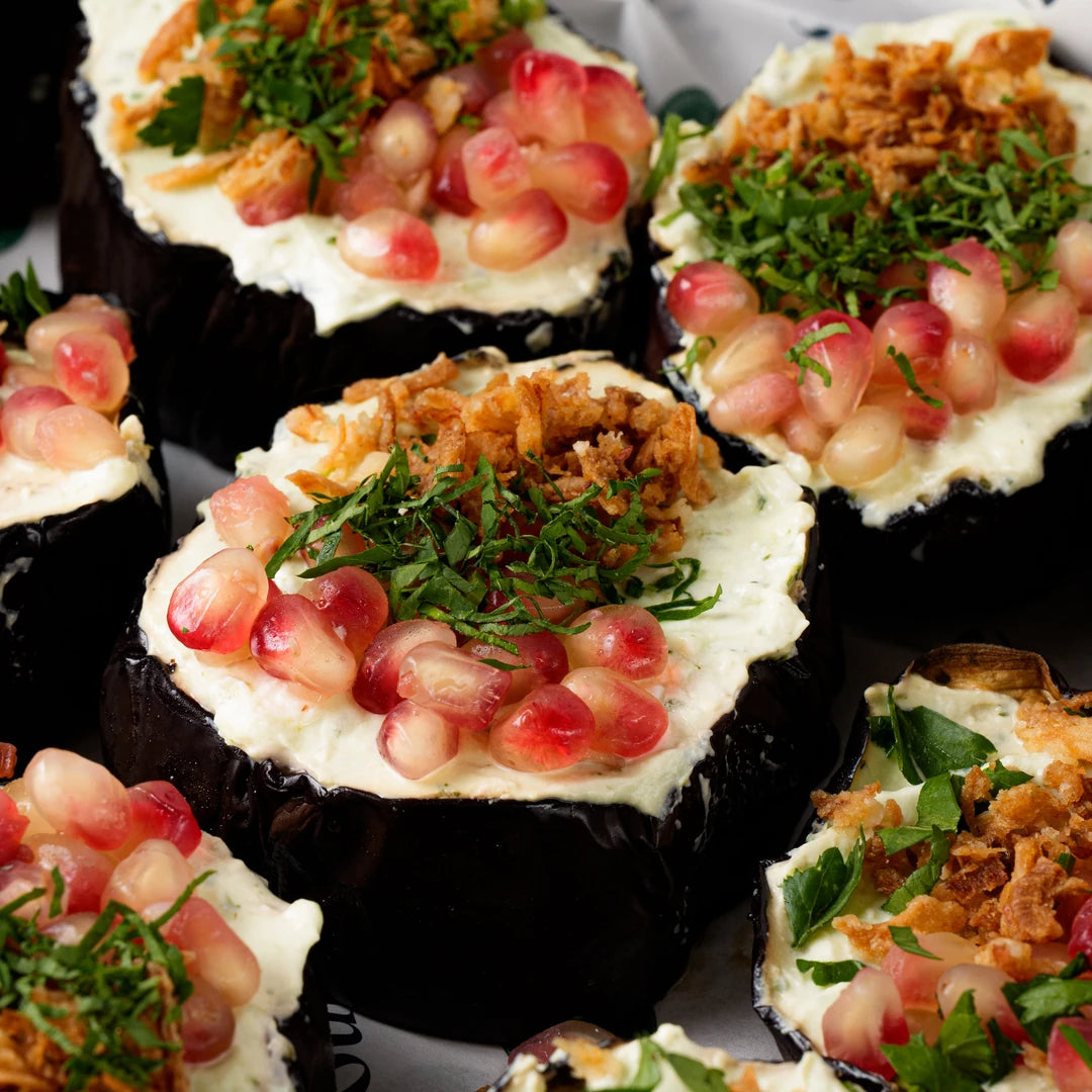 Roasted aubergine topped with feta yogurt and crispy onion, office catering London