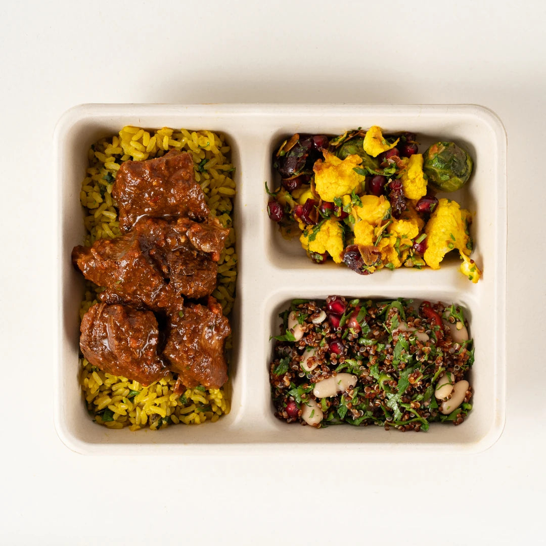 Birria Beef Lunchbox from above, hot beef on herb brown rice with two winter salads - Route Catering