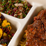 Close-up of slow cooked birria beef on lemon and herb brown rice - Route Catering