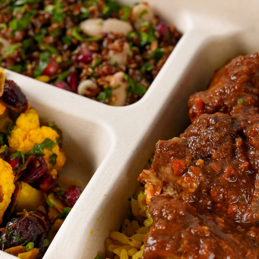 Close-up of slow cooked birria beef on lemon and herb brown rice - Route Catering