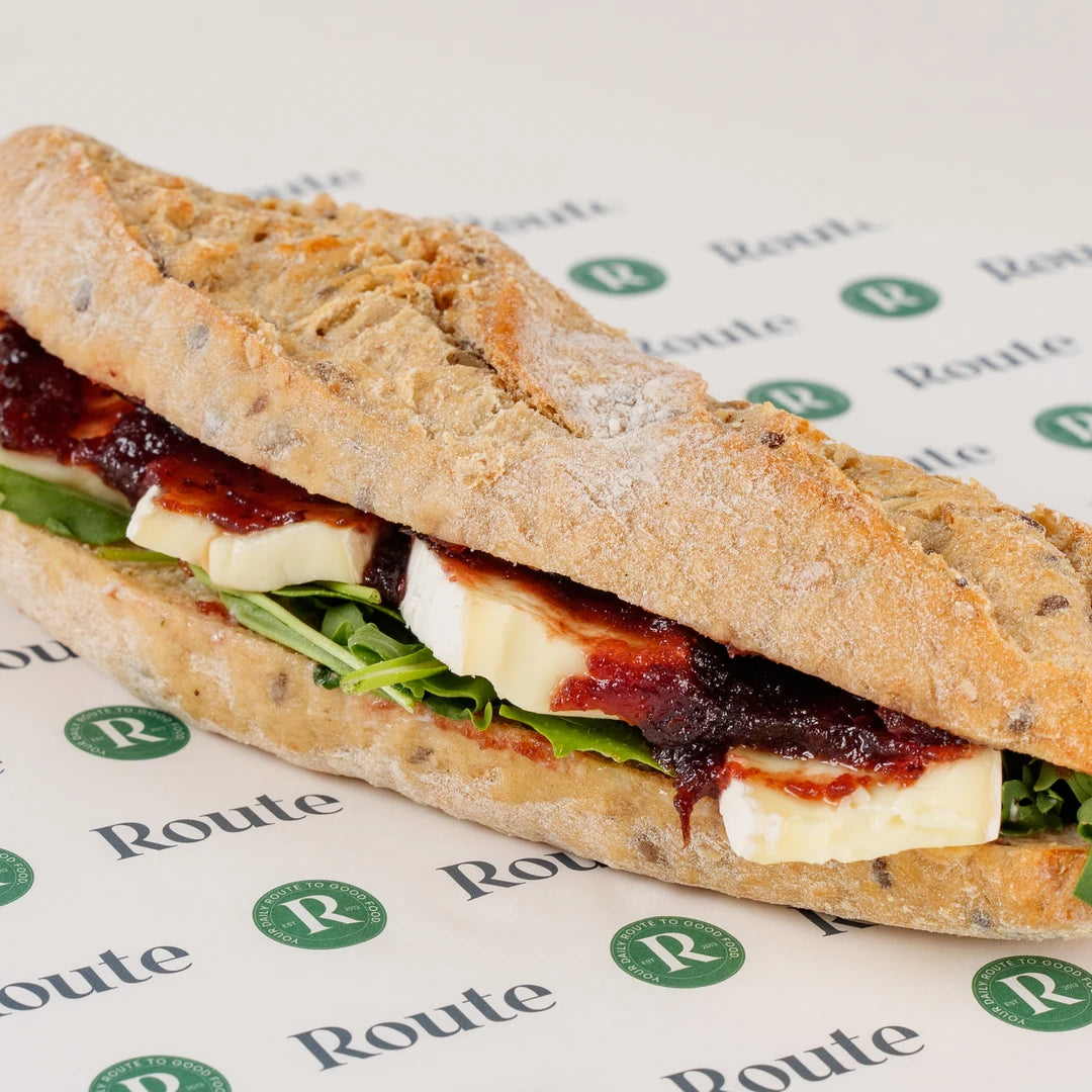 Close-up of the Brie and Cranberry Baguette filling with brie, cranberry sauce and rocket - Route Catering