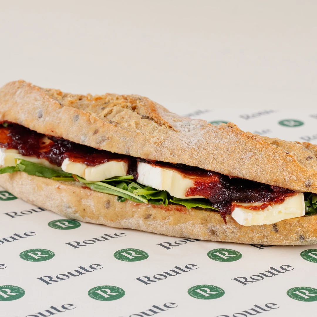 Brie and Cranberry Baguette with rocket on Route Catering paper, whole baguette