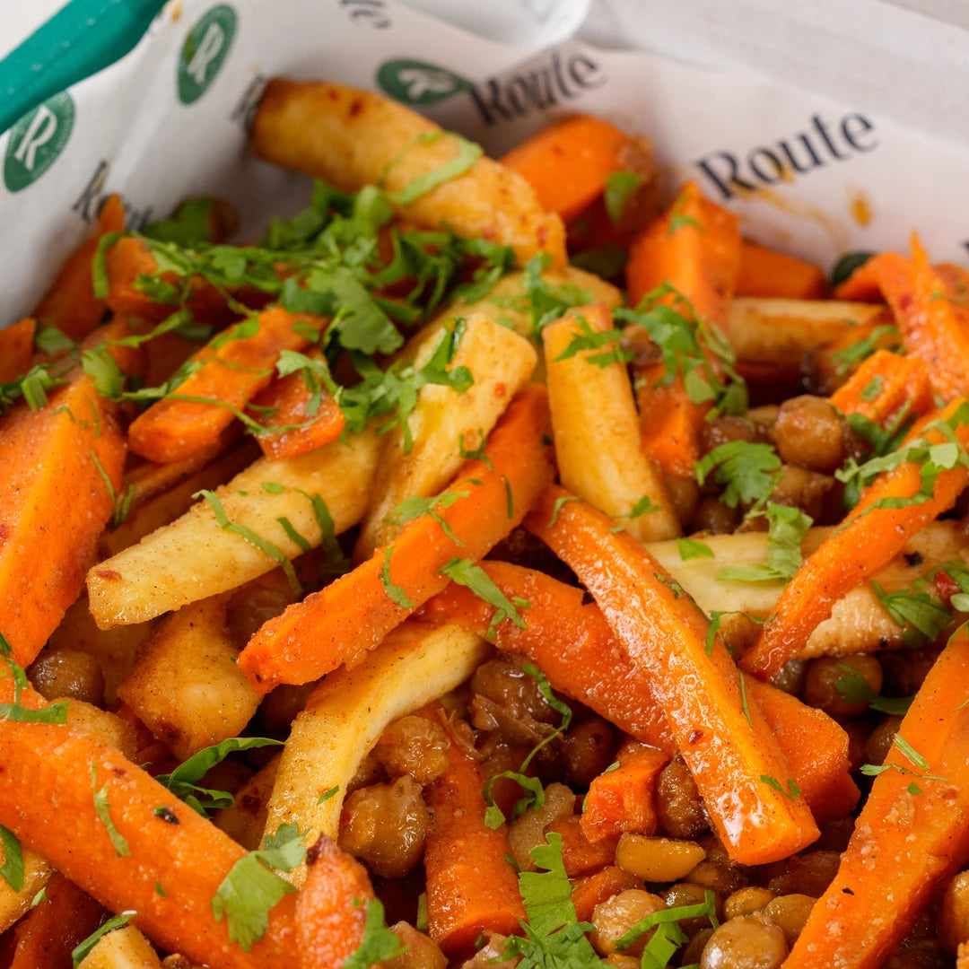 Close-up of roasted carrot and parsnip salad with chickpeas and pomegranate molasses - Route Catering