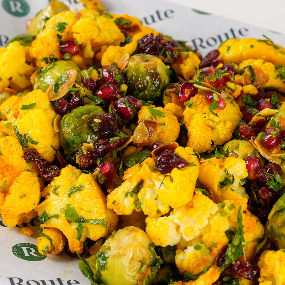 Close-up of turmeric cauliflower and Brussels sprouts with pomegranate and cranberry - Route Catering