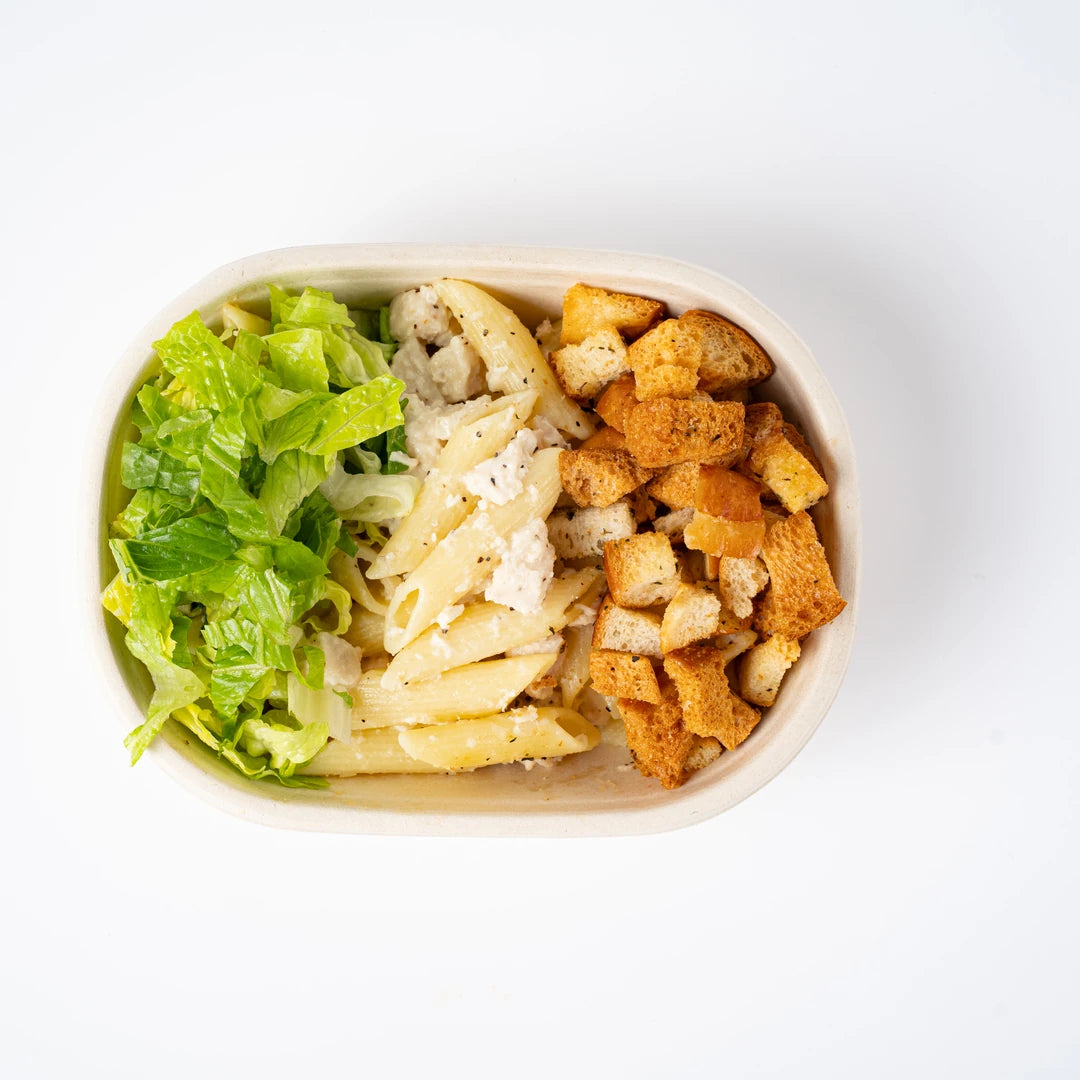 Chicken Caesar pasta with lettuce and croutons, viewed from above, Route Catering London
