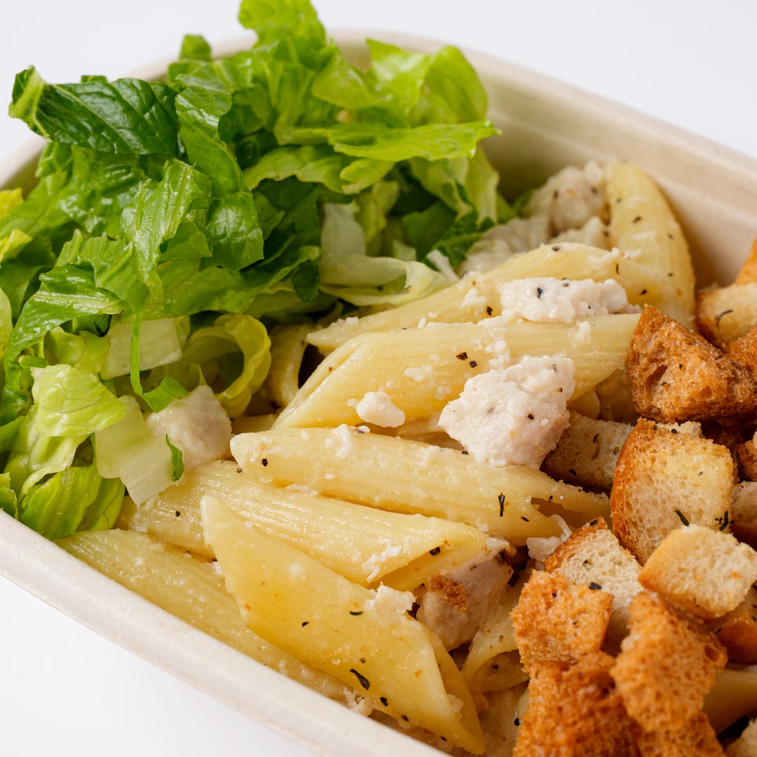 Close up of chicken Caesar pasta with parmesan and croutons, Route Catering London