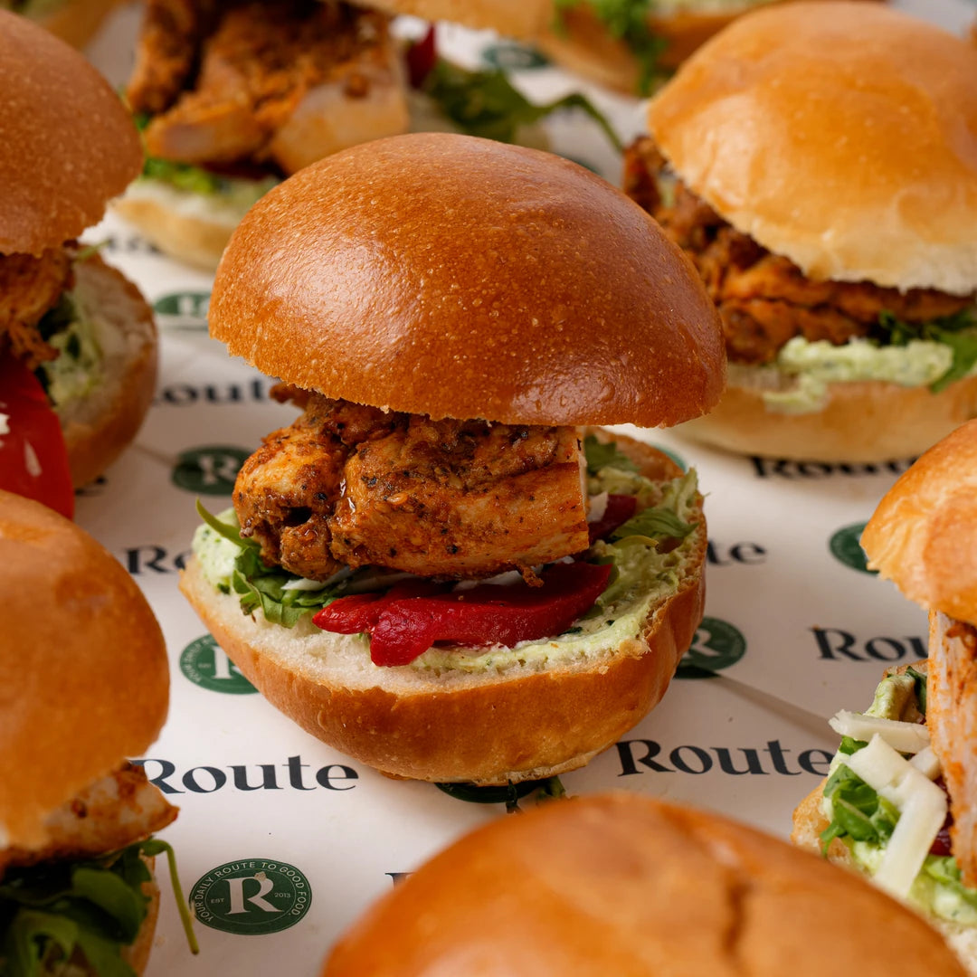 Close up of chicken slider with rocket in a brioche bun, Route Catering London