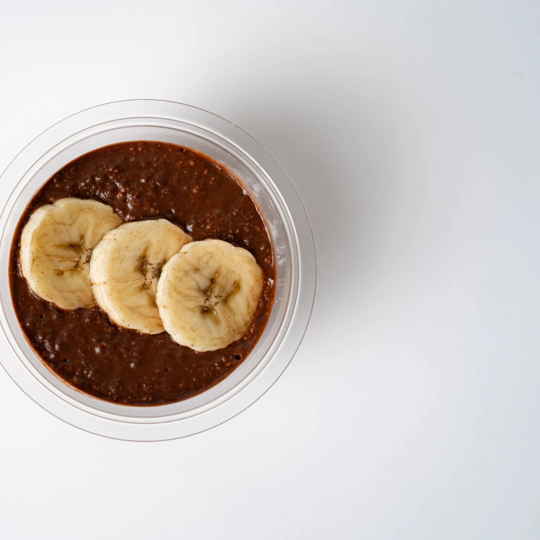 Chocolate chia pot topped with sliced banana, Route Catering London