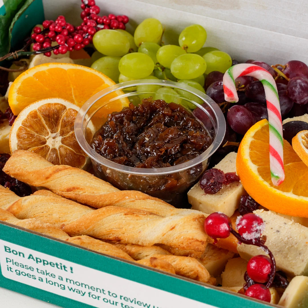 Close-up of the Christmas cheese platter with grapes, chutney and breadsticks - Route Catering