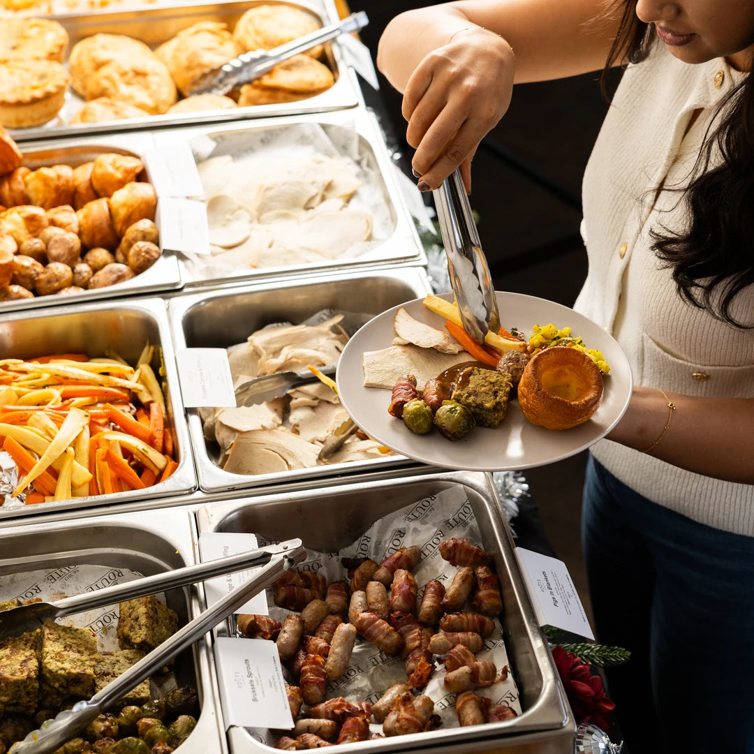 Route Catering serving a plate of Christmas dinner with pigs in blankets at an office pop-up