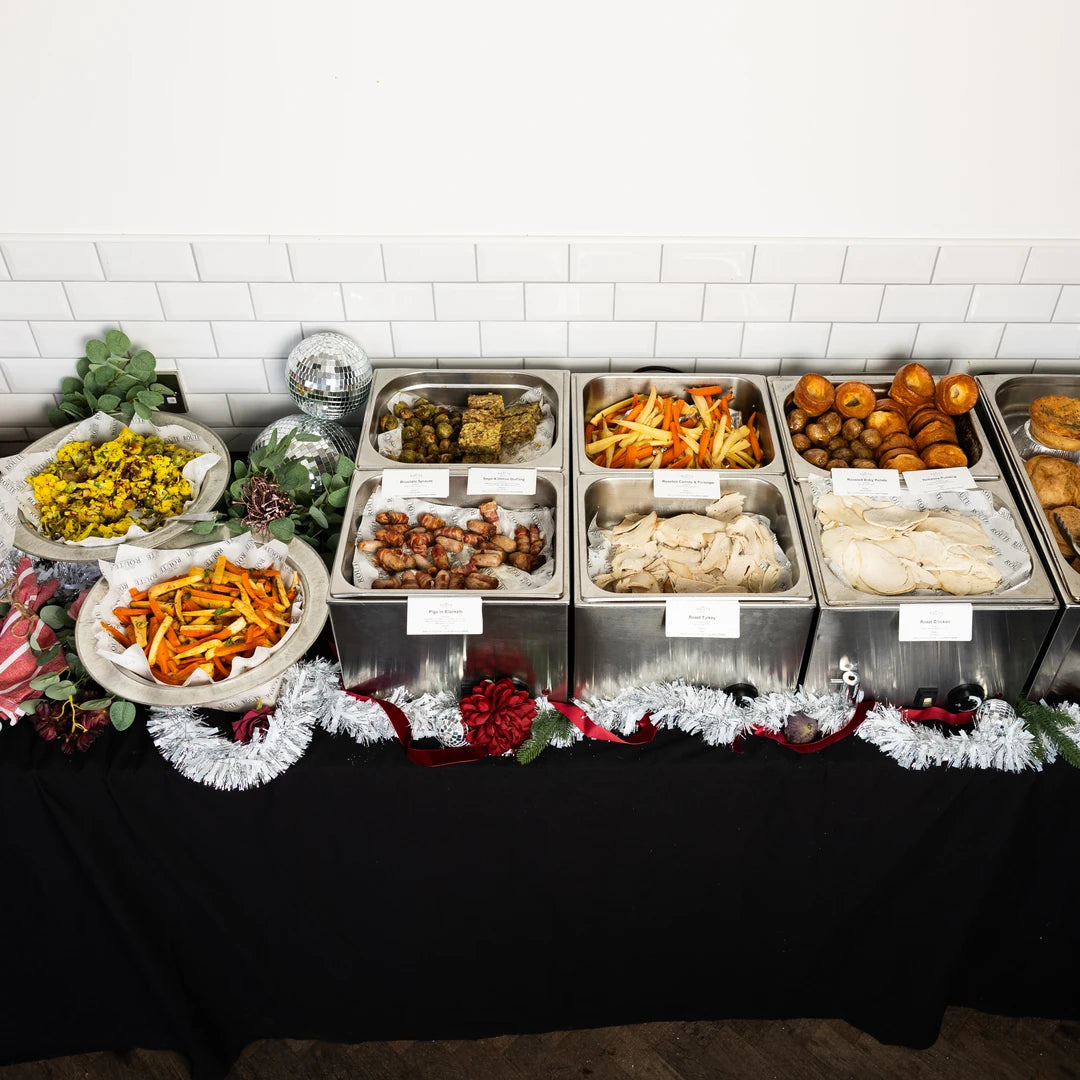 Christmas dinner pop-up buffet line with roast turkey, trimmings and festive decorations by Route Catering