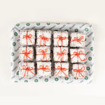 Christmas Snow Square Cakes, 12 coconut-coated squares tied with red ribbon from above - Route Catering