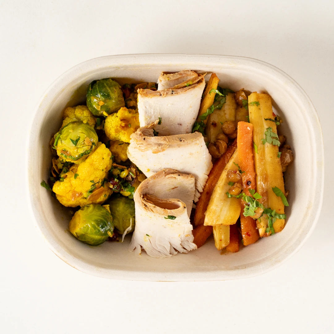 Xmas Turkey Lunchbox from above, sliced roast turkey on Brussels sprout and cauliflower salad and carrot and parsnip salad - Route Catering