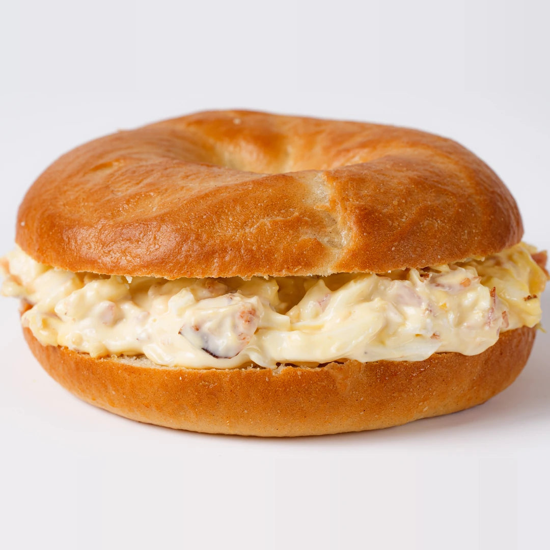 Close up of crispy bacon and boiled egg bagel, Route Catering London