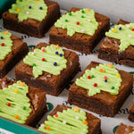 Close-up of festive brownie bites with Christmas tree icing and sprinkles - Route Catering