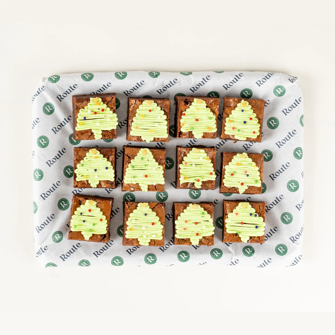 Festive Brownie Bites, 12 brownies iced with green Christmas trees from above - Route Catering