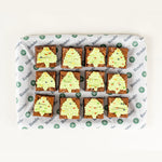 Festive Brownie Bites, 12 brownies iced with green Christmas trees from above - Route Catering