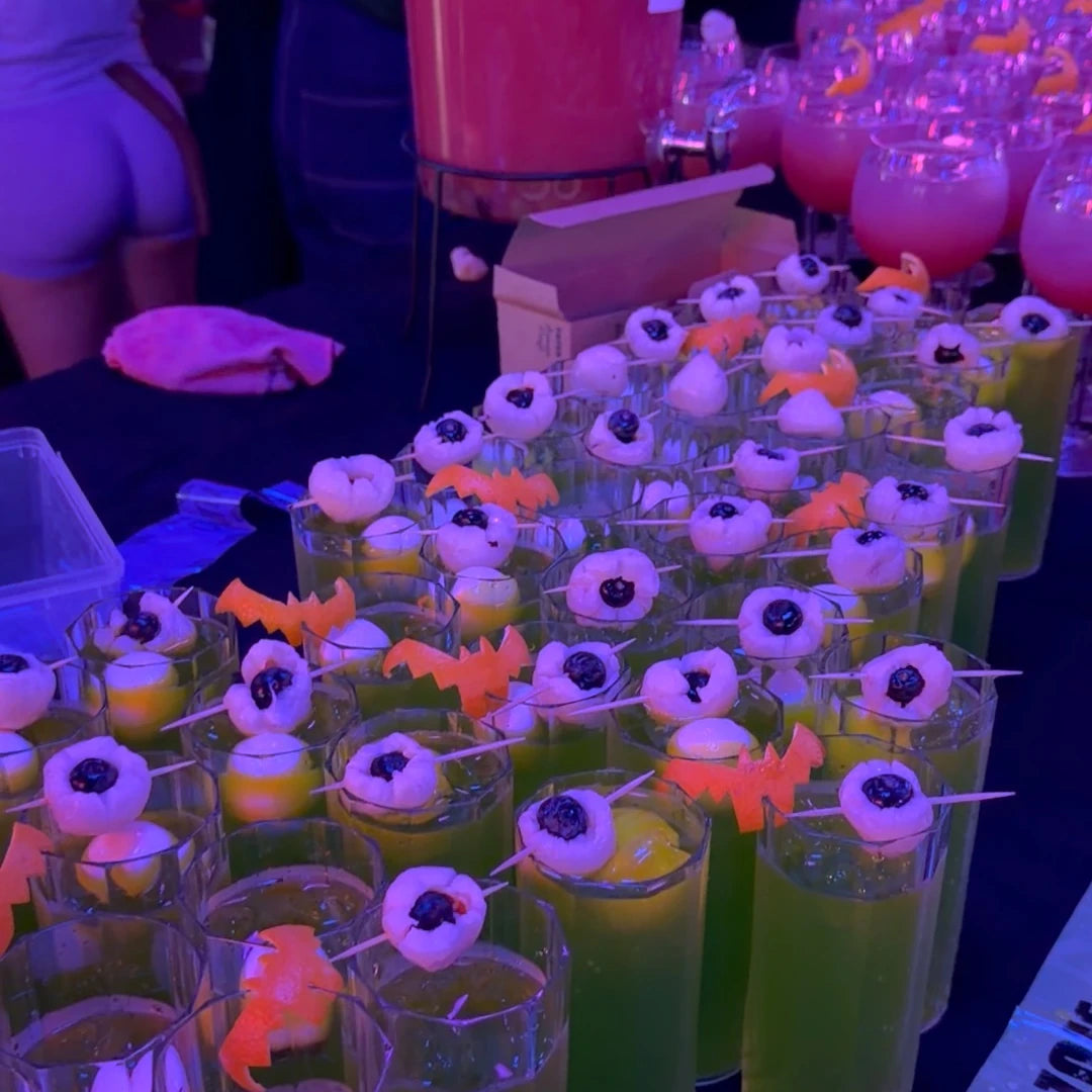 Halloween cocktail pop-up under purple party lighting at a London office event