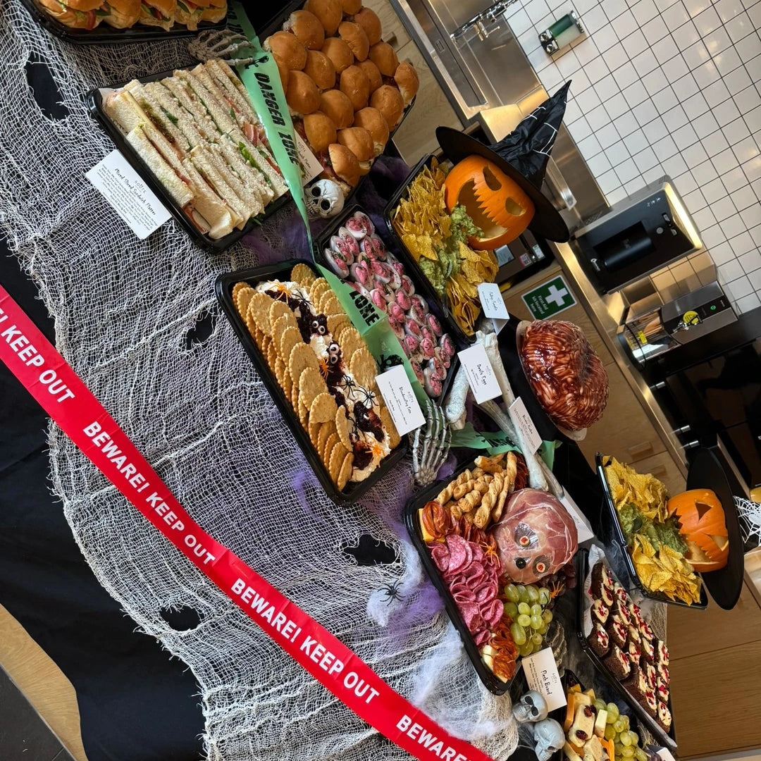 Halloween graze platters with sandwiches, charcuterie and Beware Keep Out ribbon