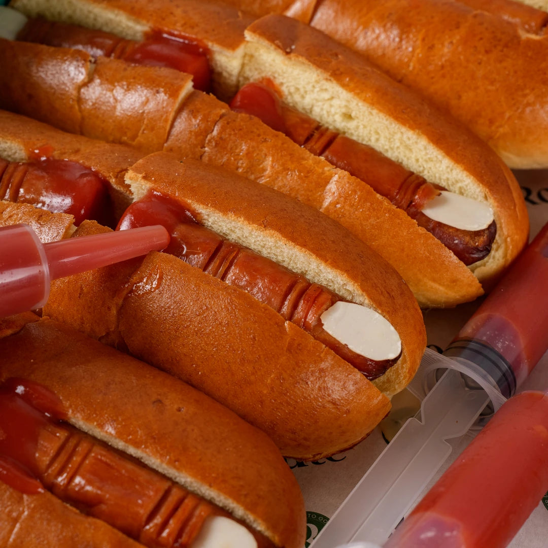Close-up of Halloween hot dog fingers in brioche rolls with almond nails - Route Catering