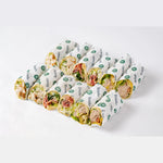Meat sandwich wraps arranged on branded paper, office catering London, Route Catering