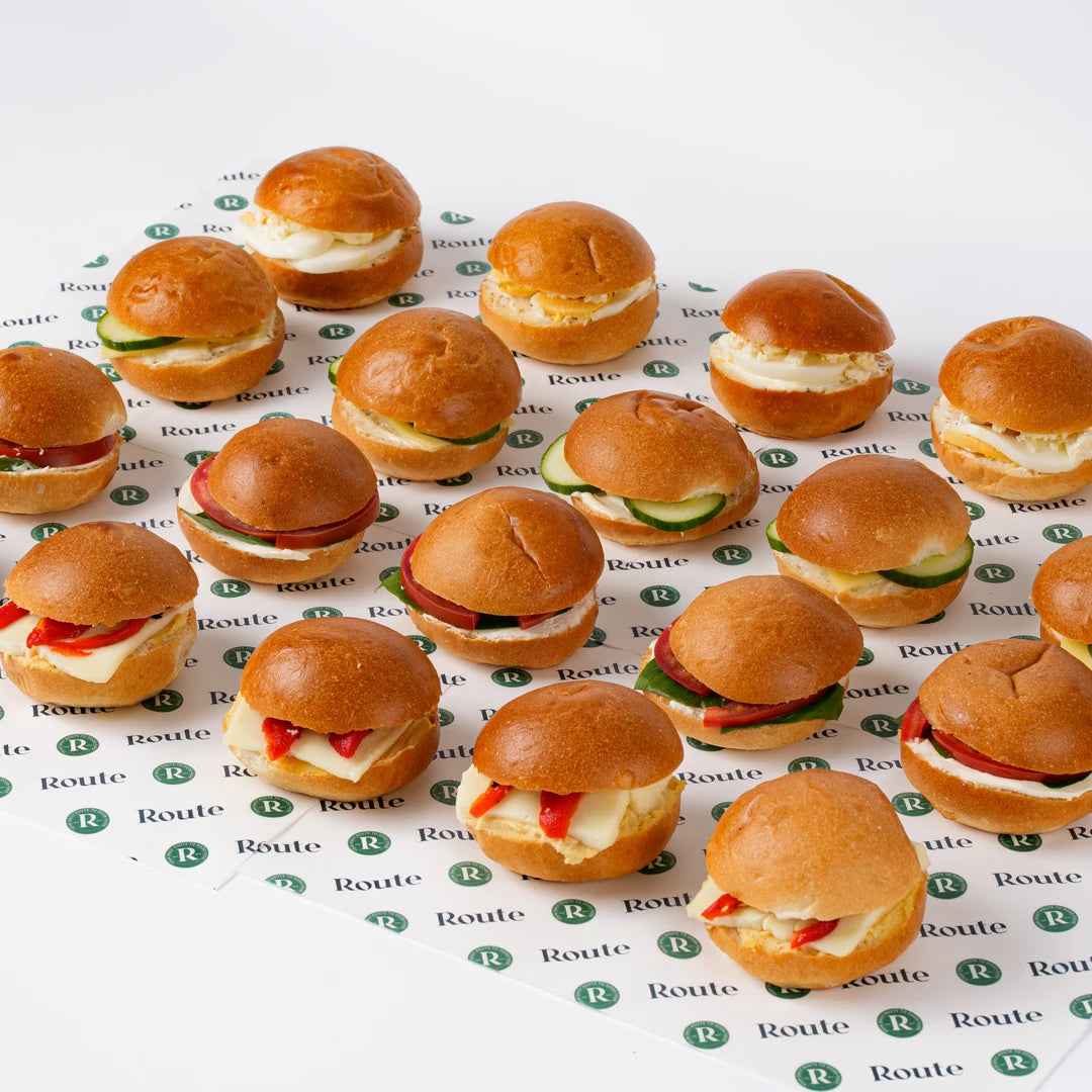 Mini veggie breakfast rolls arranged on branded paper, office catering London