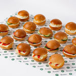 Mini veggie breakfast rolls arranged on branded paper, office catering London