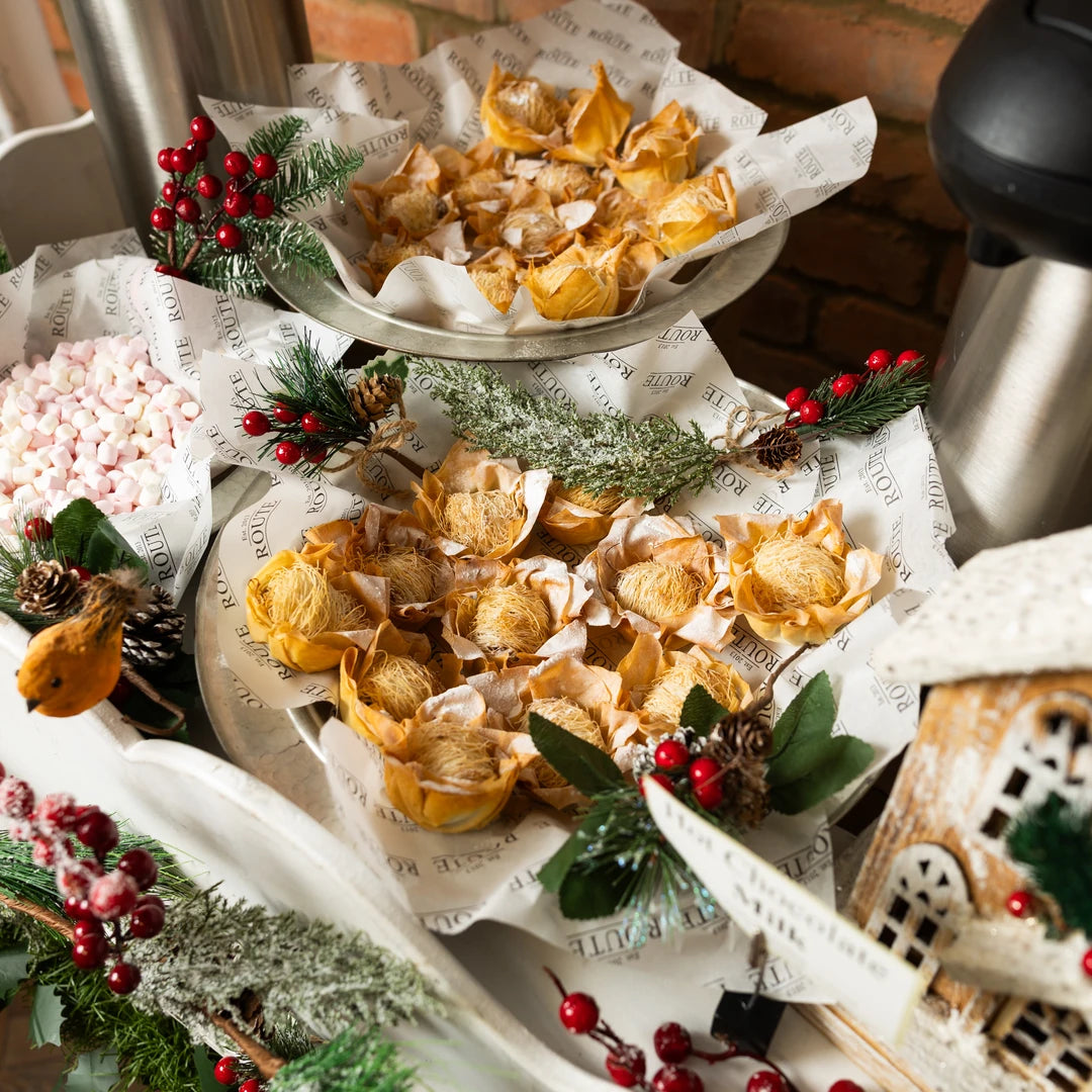 Filo mince pies and marshmallows on the mulled wine cart with a hot flask