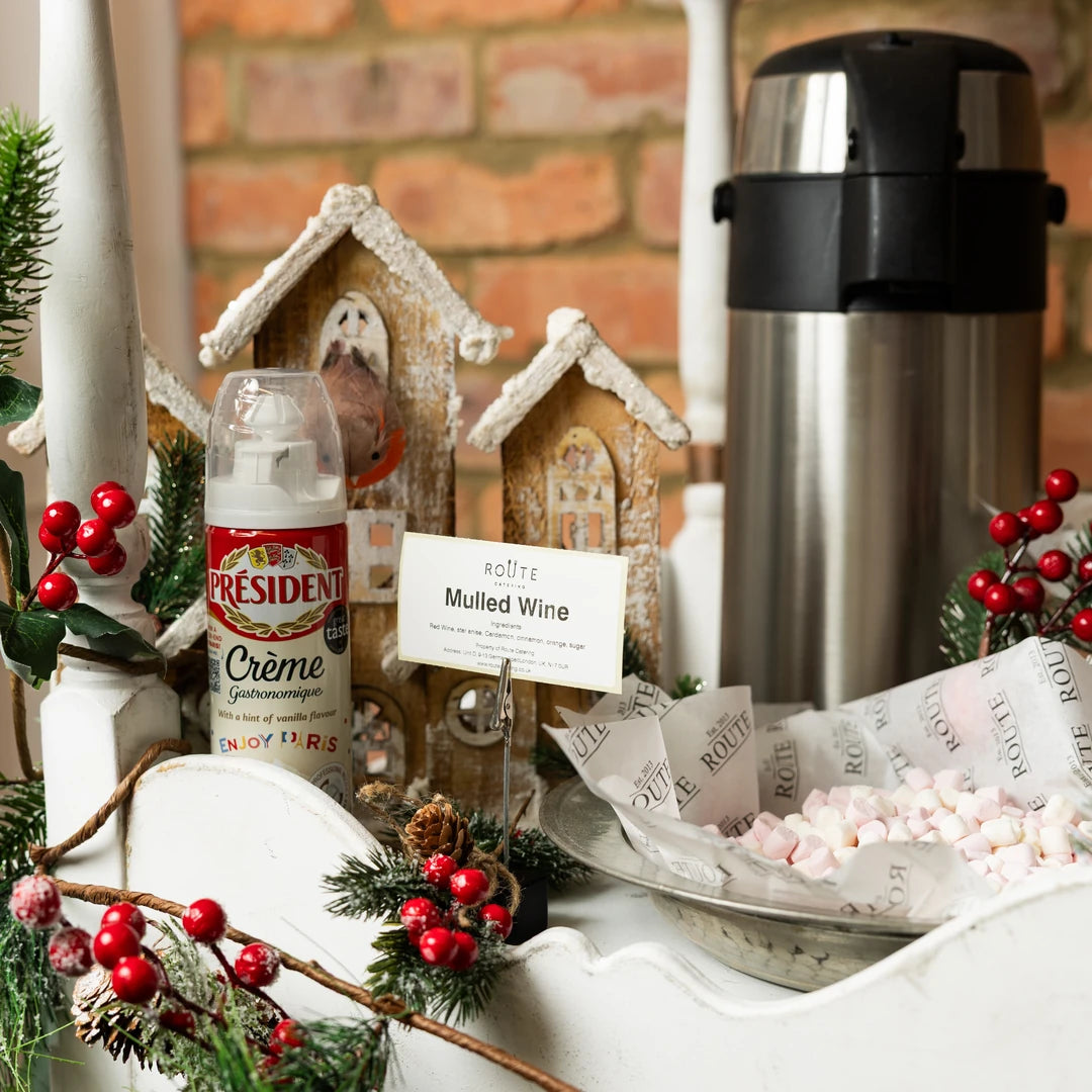 Mulled wine flask, cups and mince pies on the Christmas cart