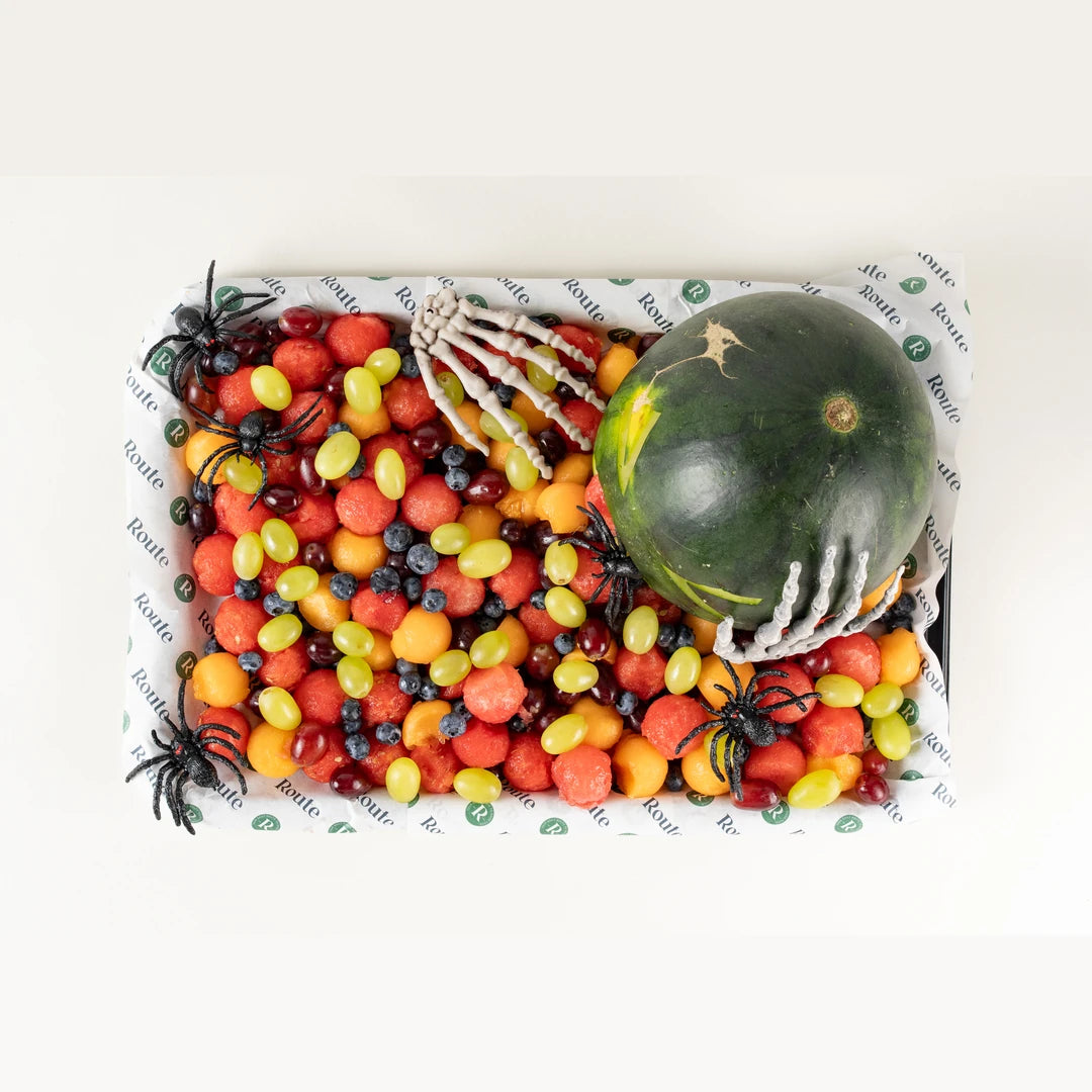 Puking Watermelon Halloween fruit platter from above with skeleton hand and spider - Route Catering