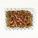 Red Quinoa Salad platter for six from above with cannellini beans, pomegranate and roasted red pepper on Route Catering paper
