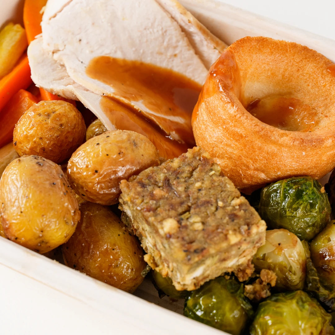 Close-up of roast chicken, Yorkshire pudding, stuffing and roast potatoes in the Roast Chicken Dinner box - Route Catering