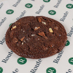 Close-up of a triple chocolate cookie on Route Catering paper