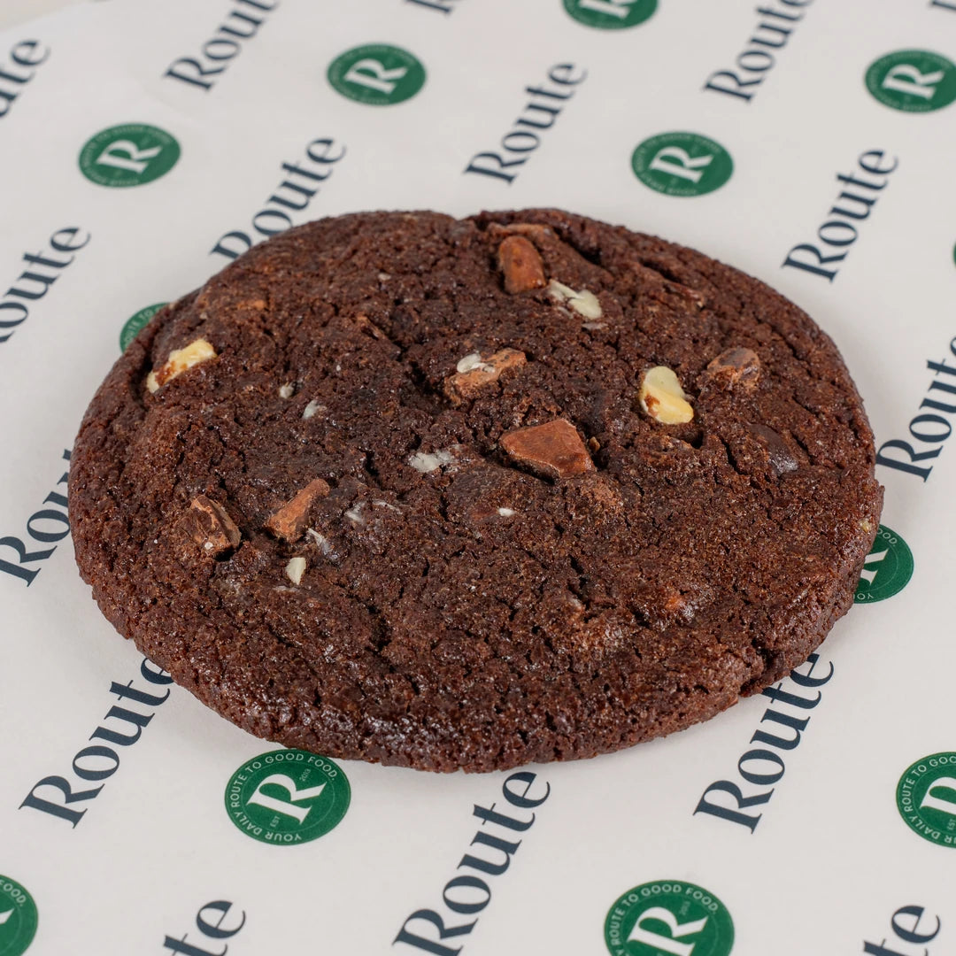 Close-up of a triple chocolate cookie on Route Catering paper