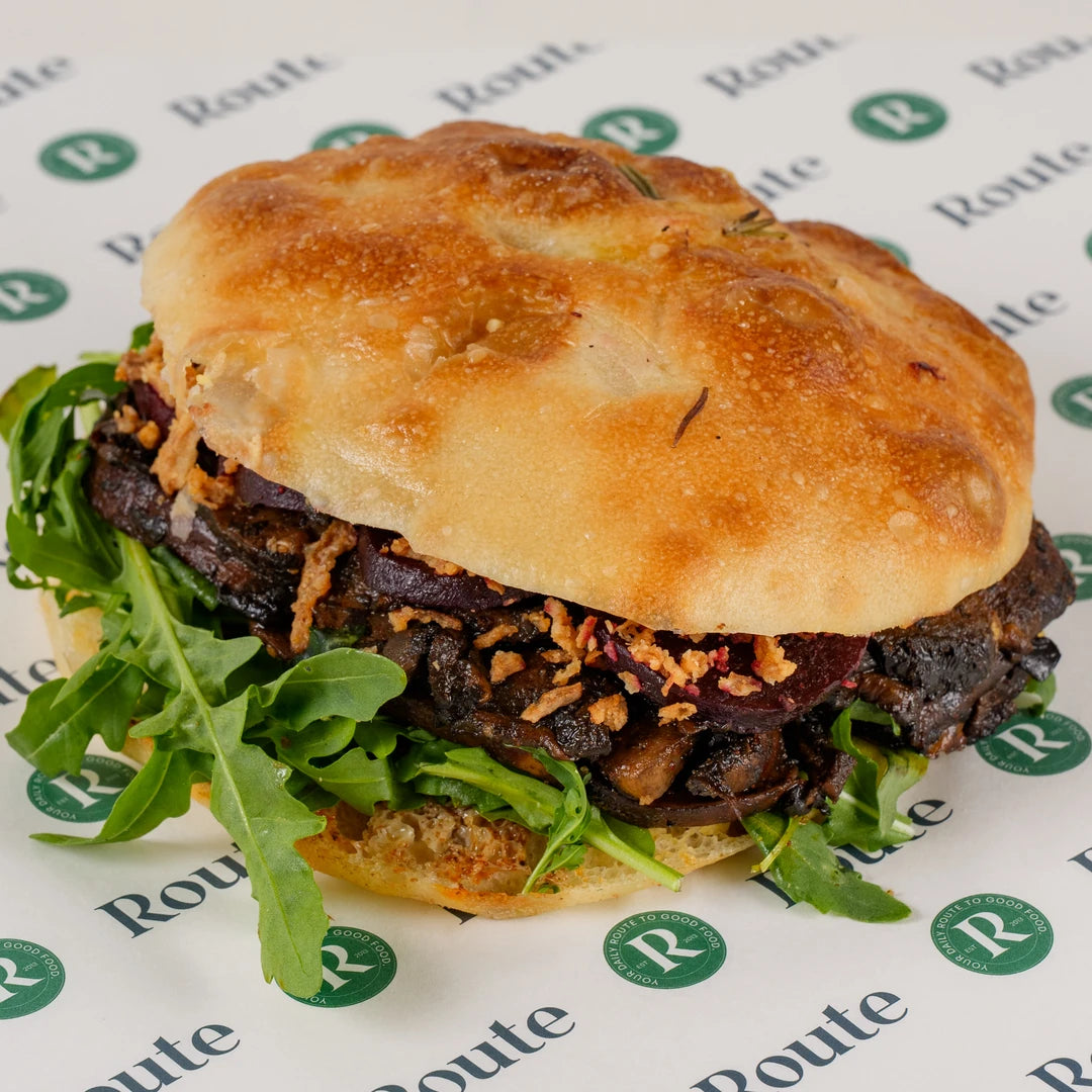 Truffle Mushroom and Maple Beetroot Focaccia with rocket and crispy onions on Route Catering paper