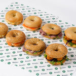 Variety bagel platter arranged on branded paper, breakfast catering London