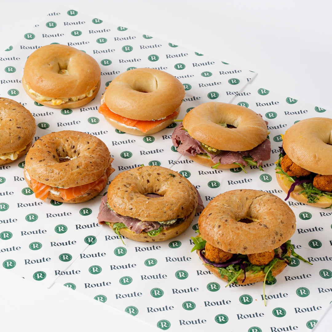 Variety bagel platter arranged on branded paper, breakfast catering London