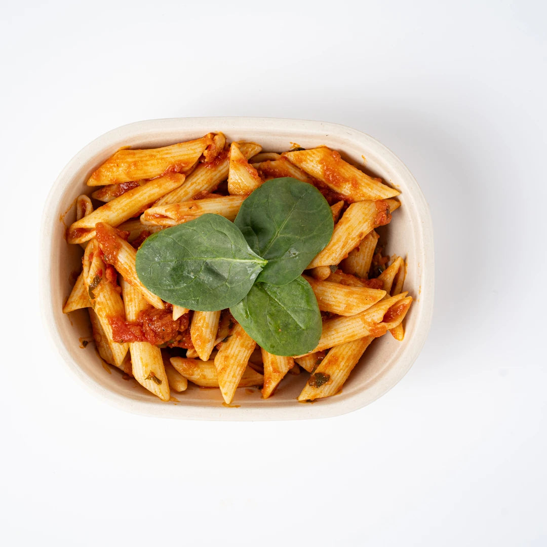 Vegan penne pasta in tomato sauce with spinach, viewed from above, Route Catering London