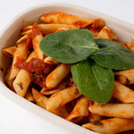 Close up of vegan penne pasta with tomato sauce and spinach, Route Catering London
