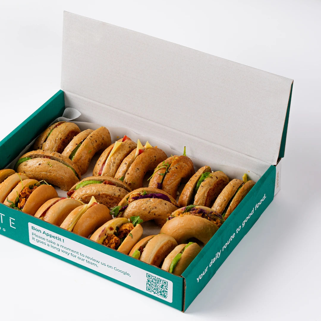 Vegetarian bagels arranged on branded paper, office breakfast catering London